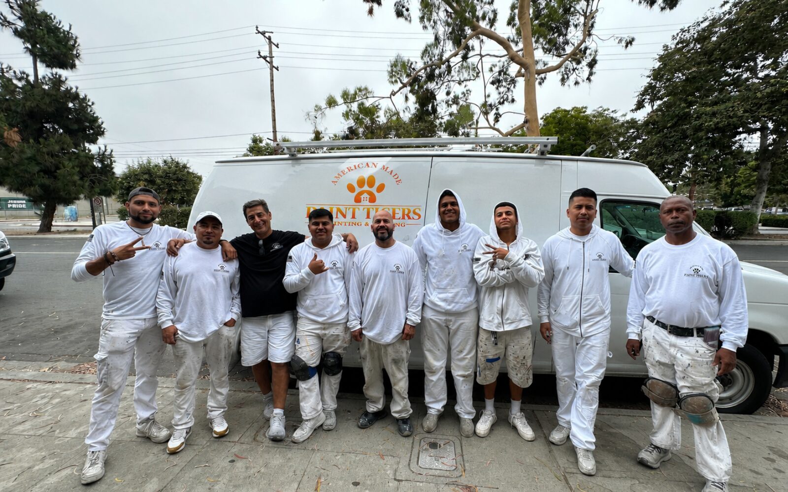 Paint Tigers crew in front of the branded van