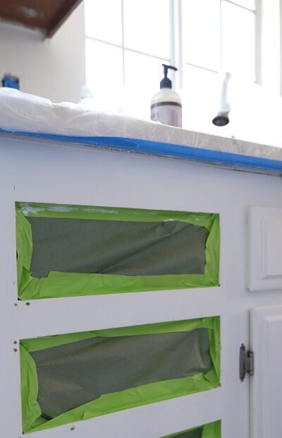 Cabinet doors masked off before painting